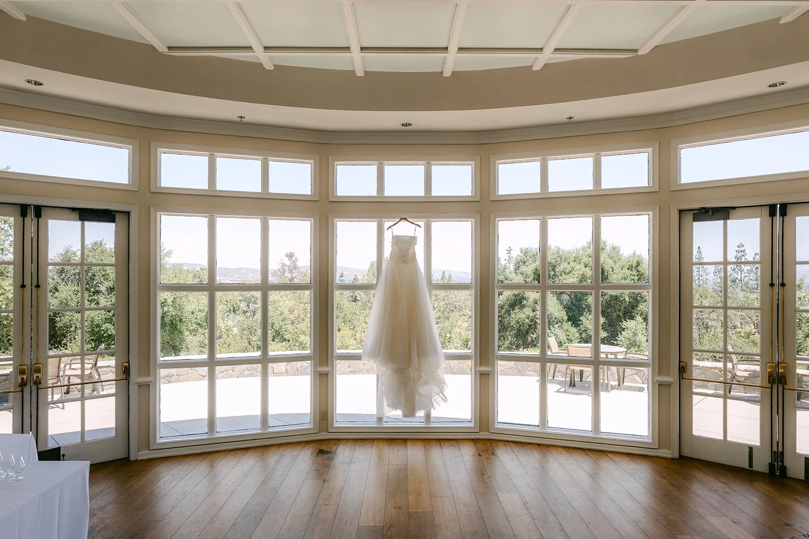 The window-lined bridal suite at Summit House with Judy's gown hanging