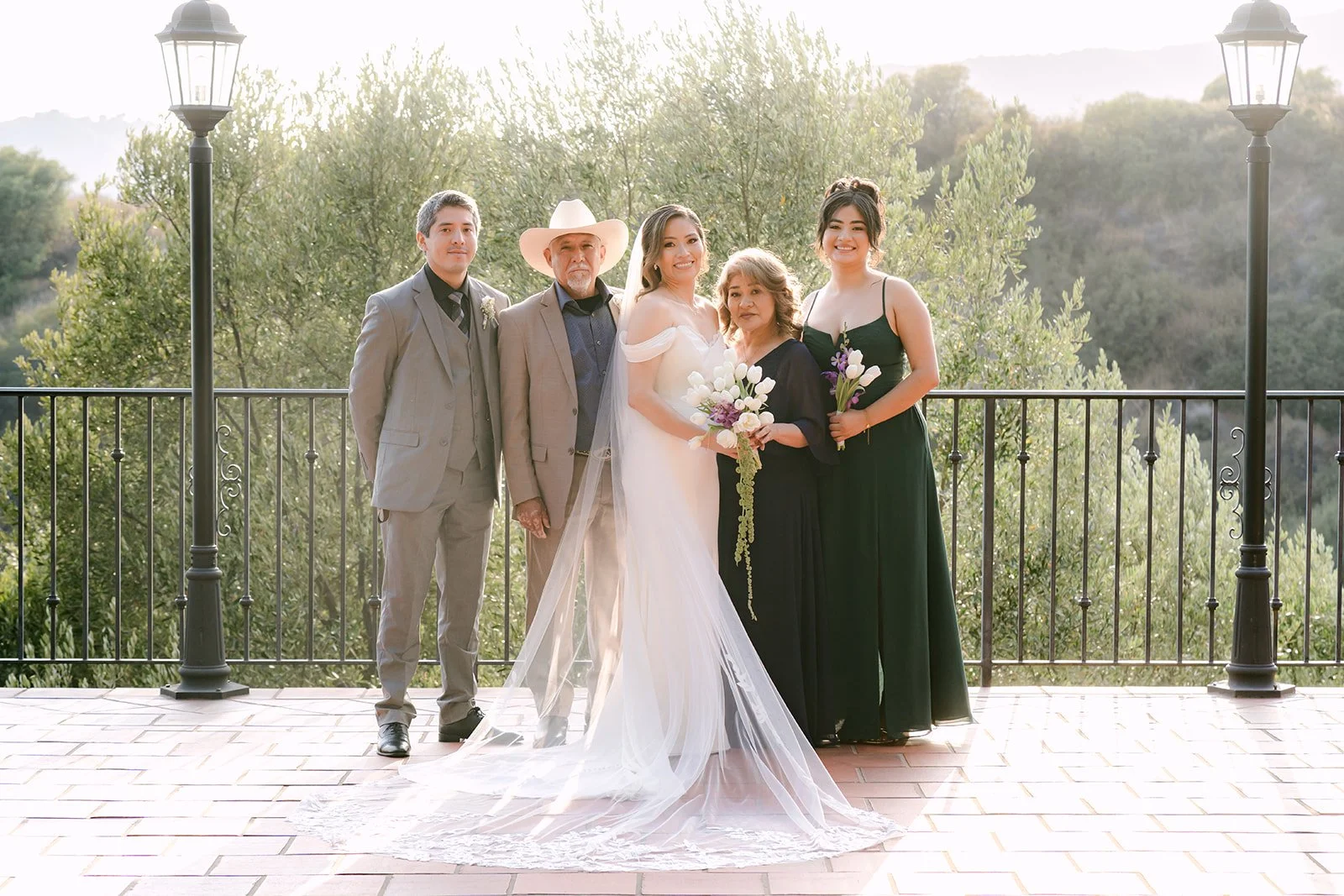 Mariana and Danny with family on the sunset terrace above the canyon