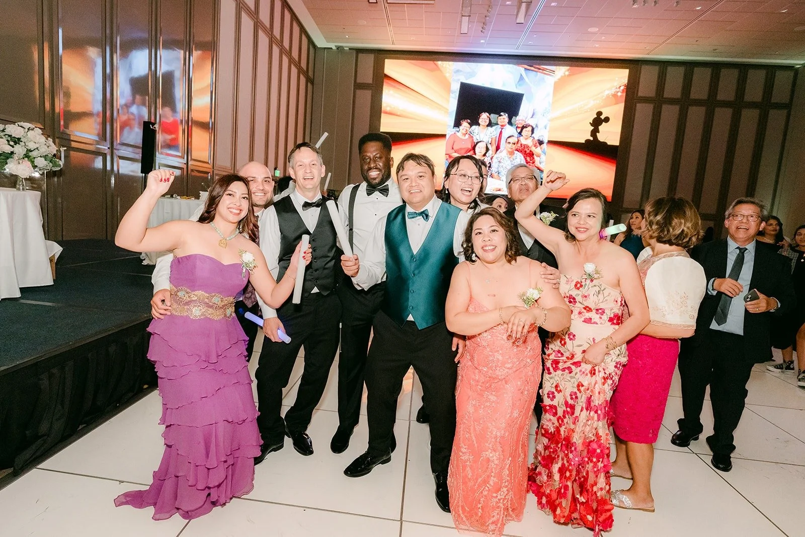 Stella, James and guests celebrating together on the dance floor