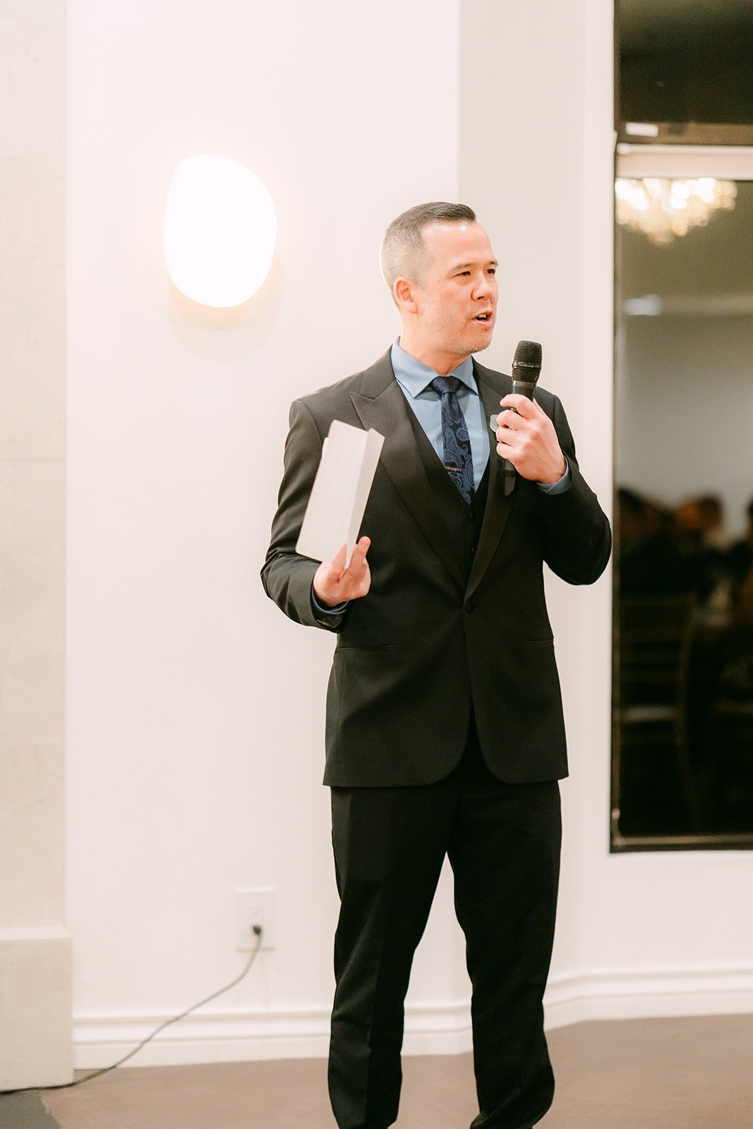 A guest gives a toast with the microphone