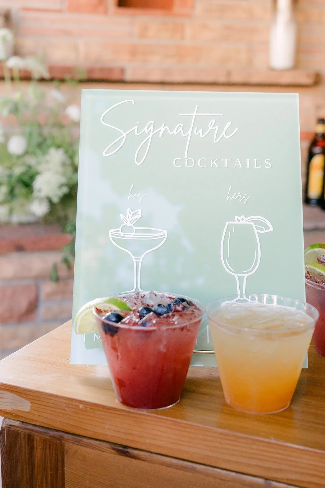 Signature cocktails on the bar with a sage green menu