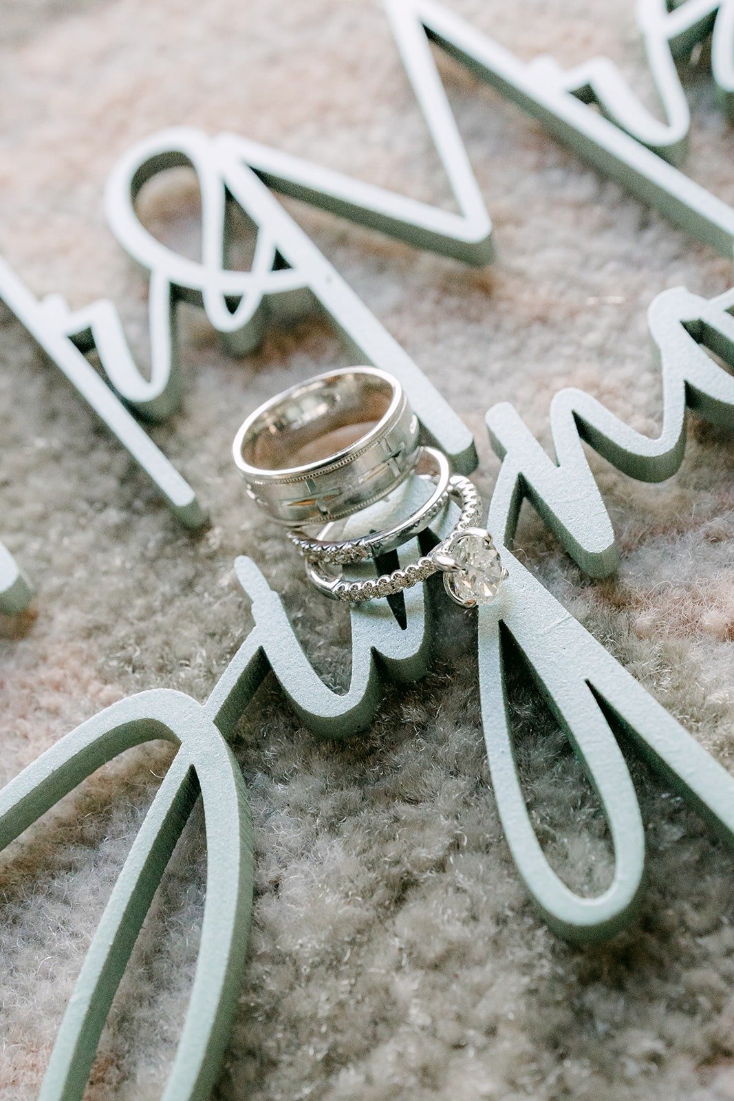 Wedding bands resting on a Mr and Mrs sign