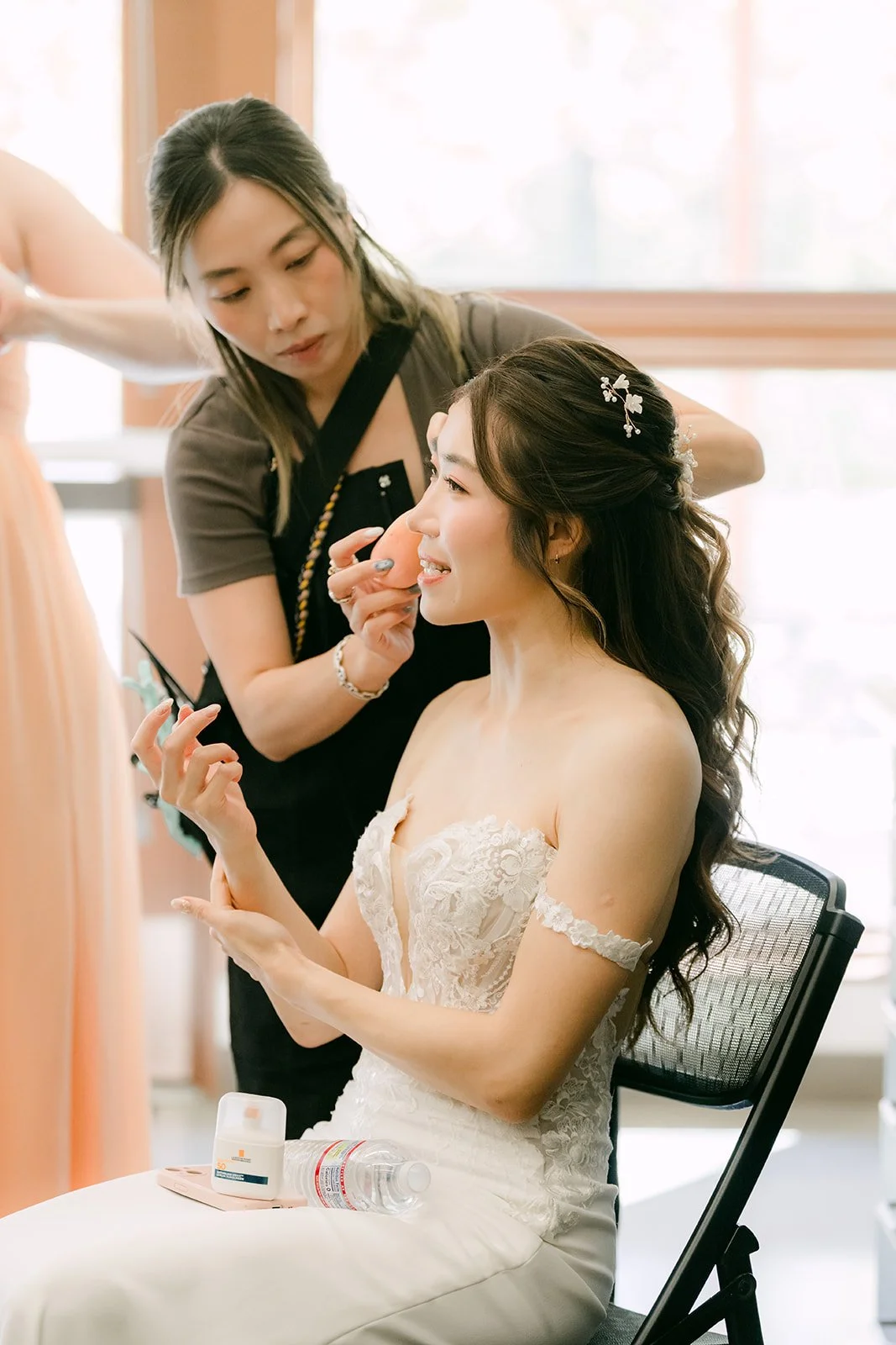 Christie's makeup artist touches up her look before portraits.