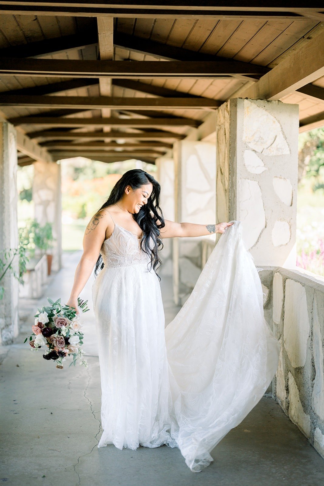 Betsy lets her veil float out in the covered walkway
