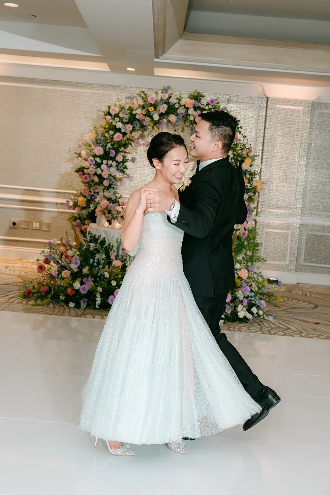 Kylie and Mario swaying together under the ballroom lights