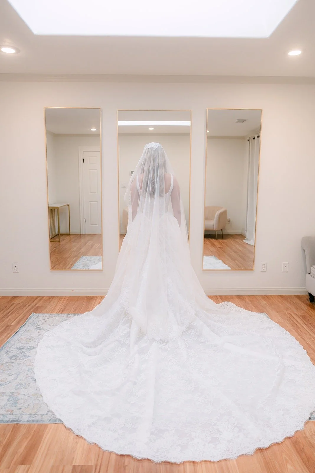 Konitha's cathedral train spread across the bridal suite floor