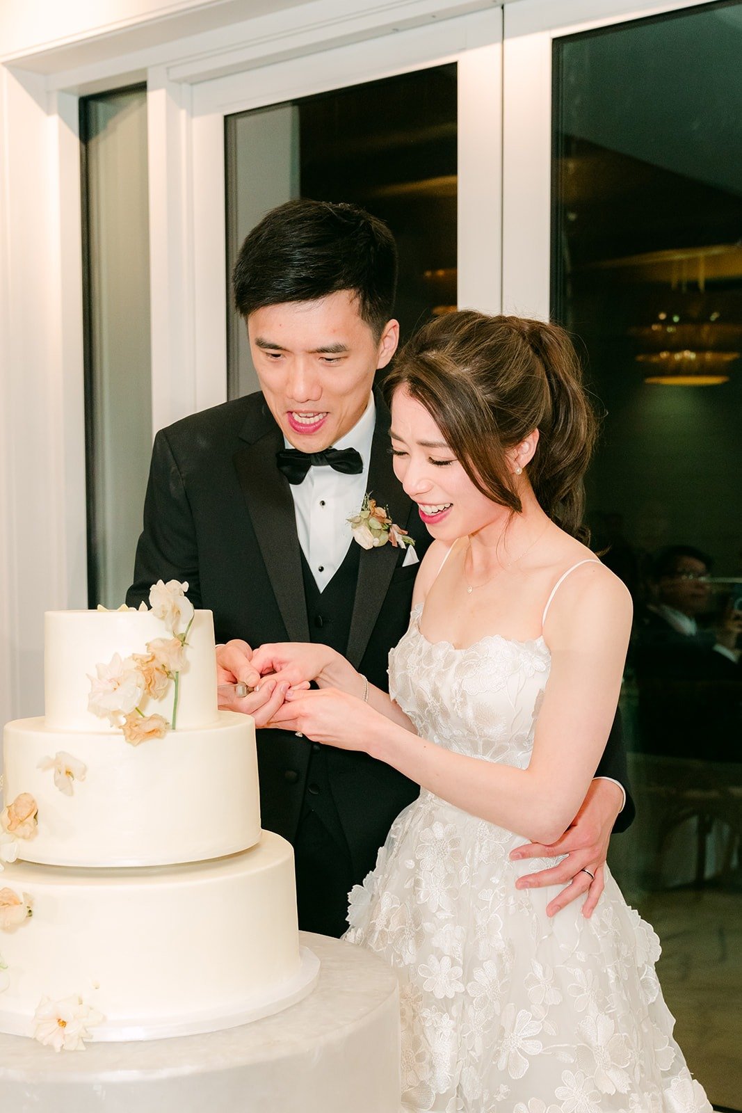 Angela and Eli cutting their wedding cake