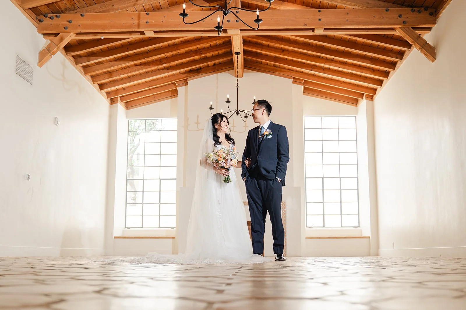 Wide portrait of Constance and Lawrence under the wood beam ceiling