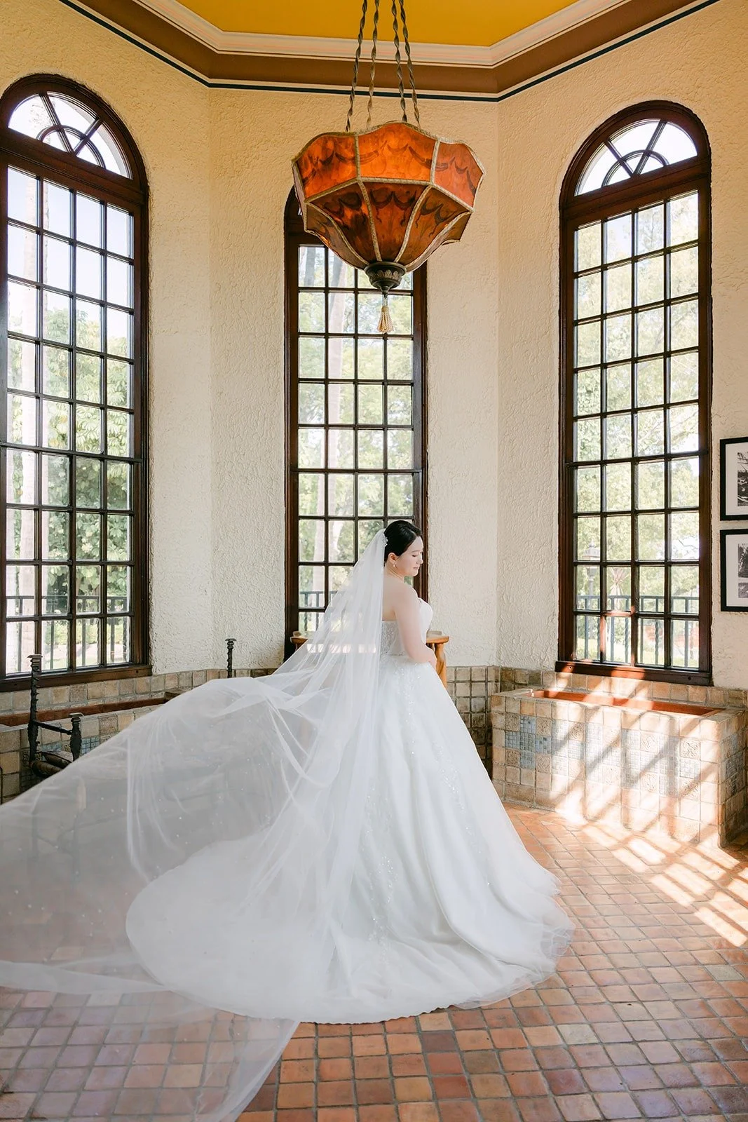 Amy in the Muckenthaler sunroom with its arched windows and lantern