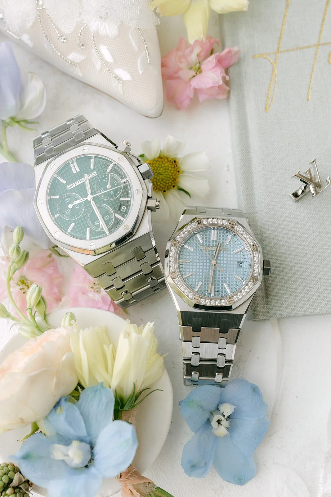 Kylie and Mario's two steel watches styled with soft blue flowers at Surf & Sand Resort