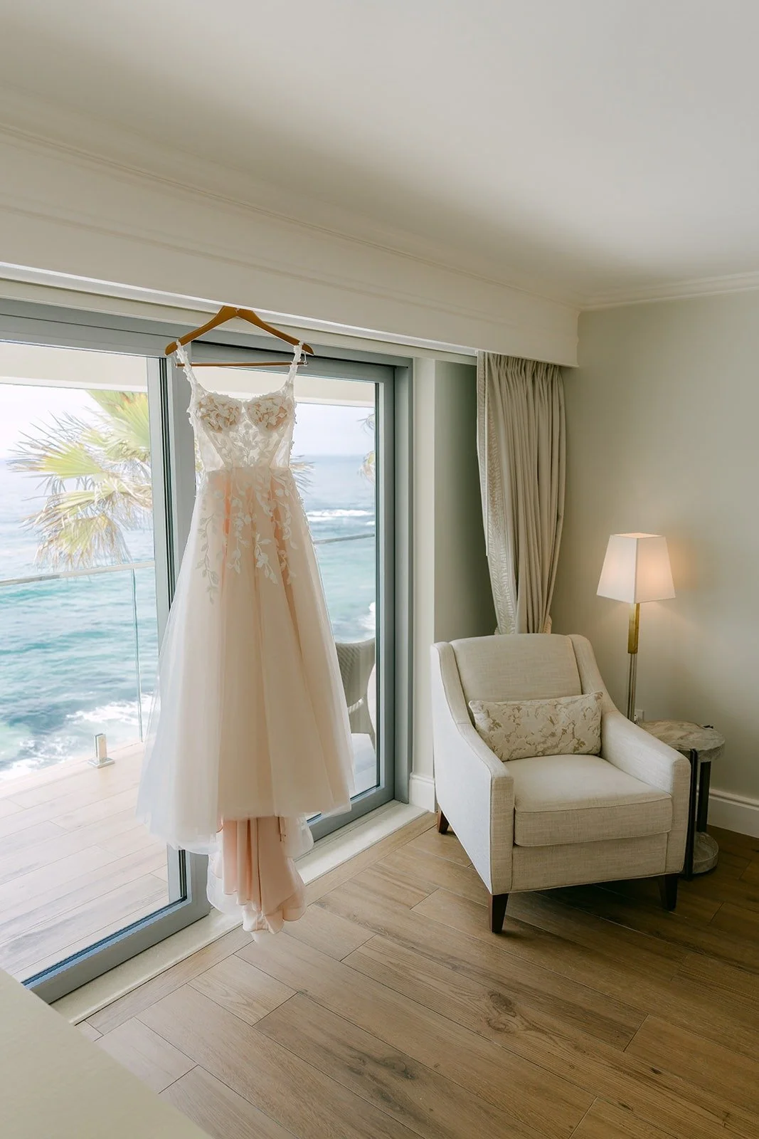 Kylie's wedding gown hanging in her ocean view room at Surf & Sand Resort