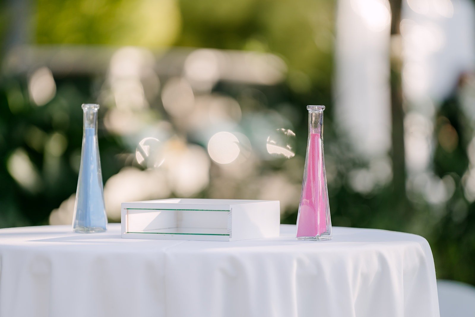 The sand ceremony table with bottles of colored sand