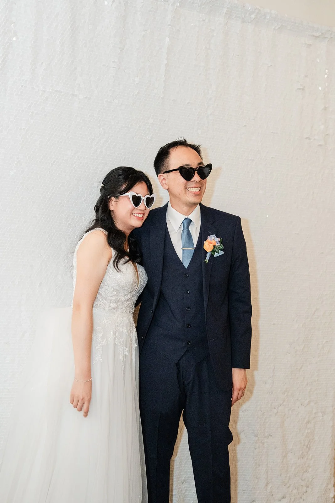 Couple posing with sunglasses at the photo booth