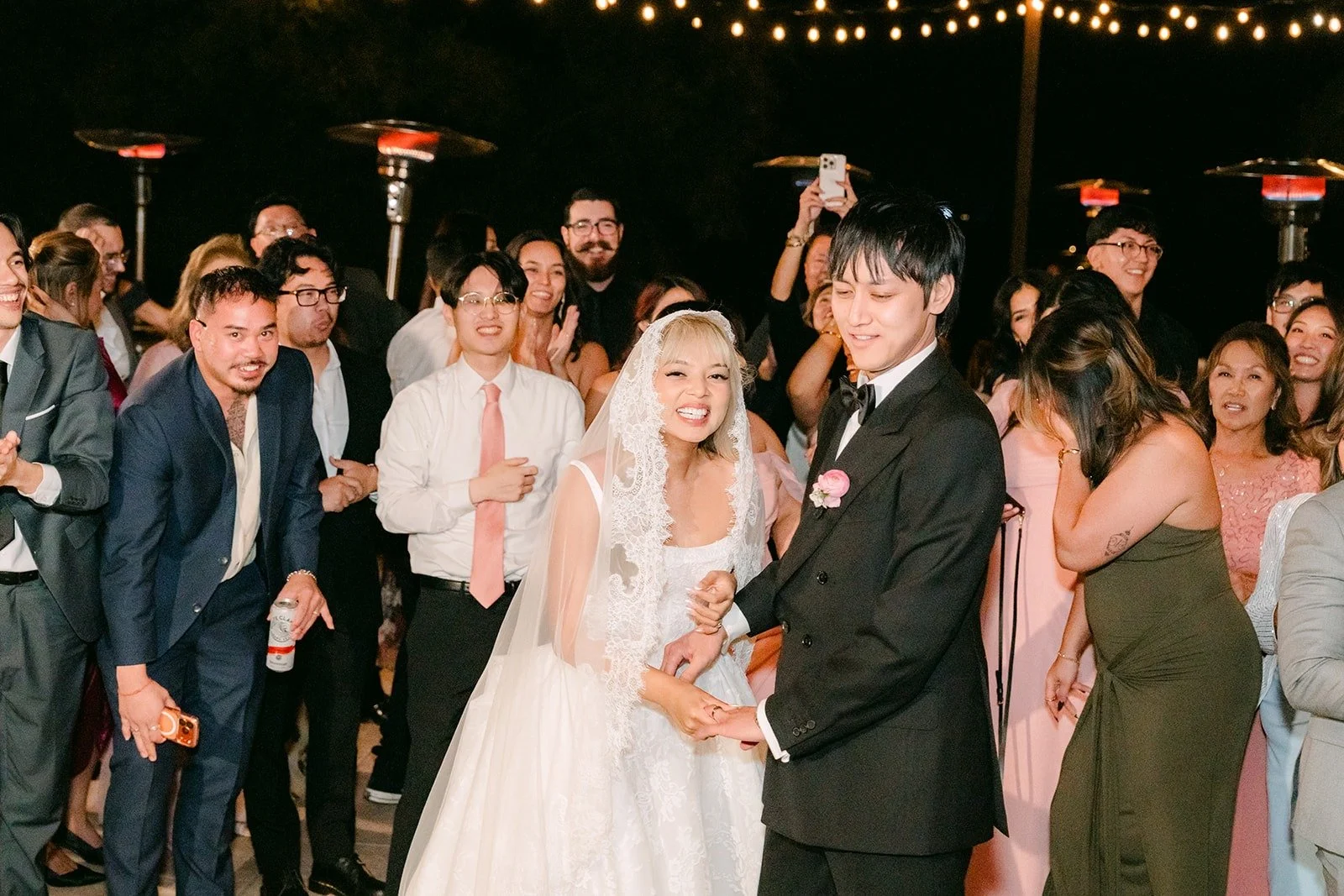 Konitha and Job surrounded by guests on the dance floor