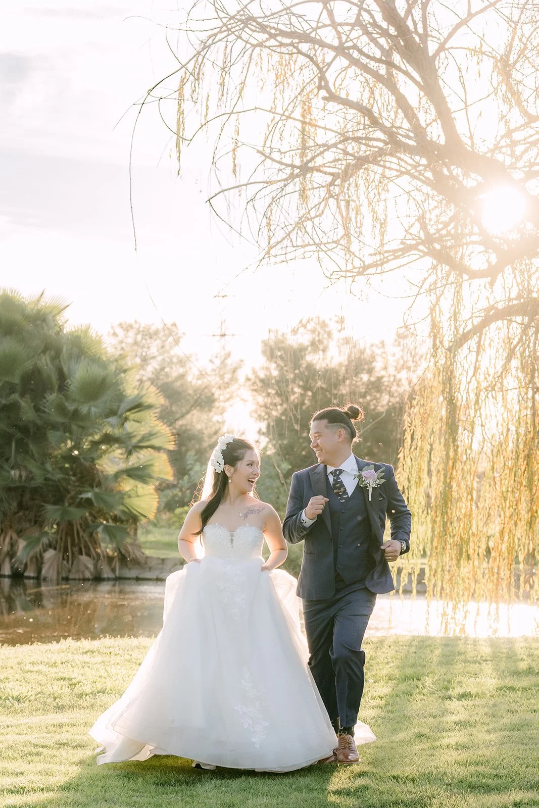 Kate and Michael walking across the golf course at golden hour.