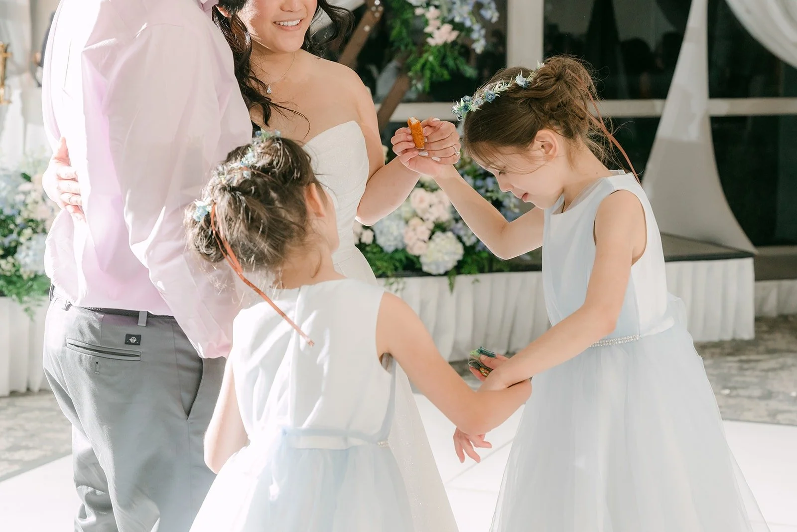 The flower girls twirling on the dance floor