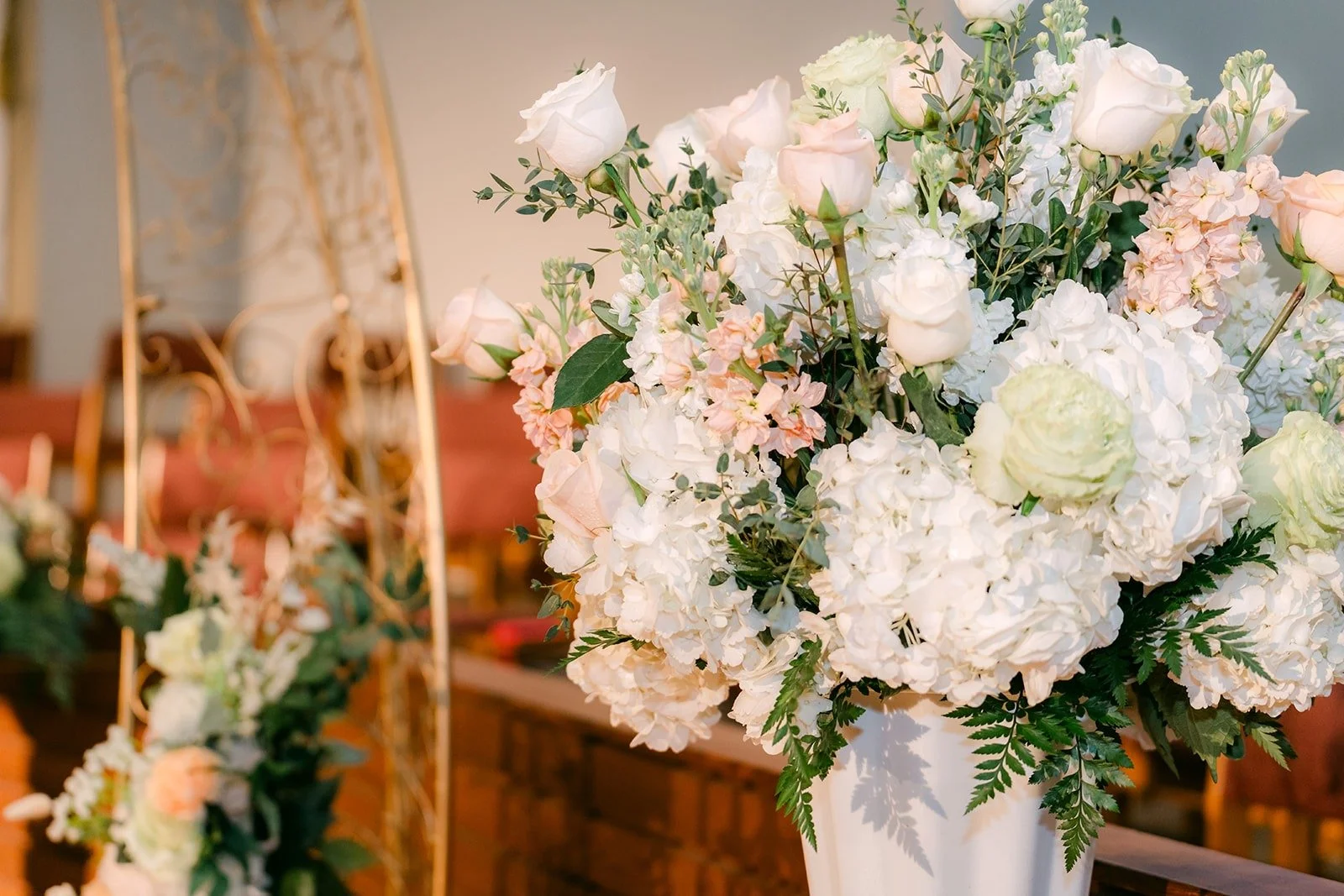 White and blush florals lining the aisle