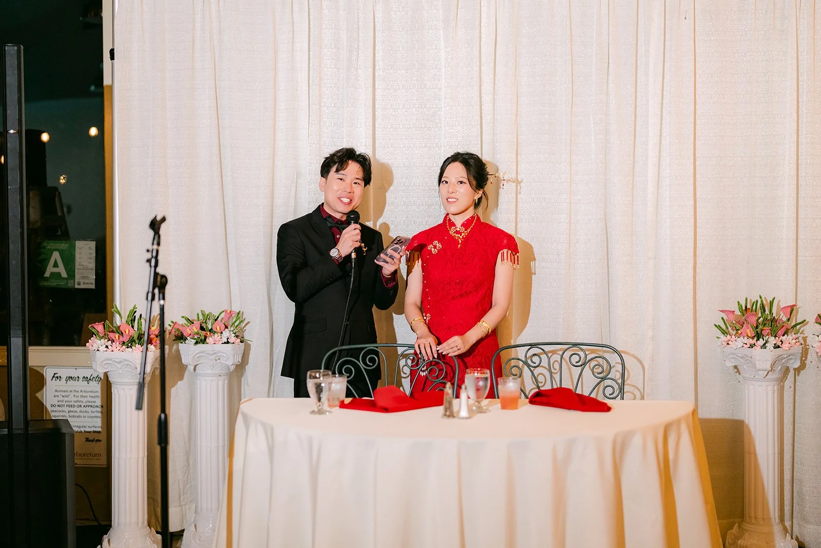Elaine and Wen at the sweetheart table with the mic.