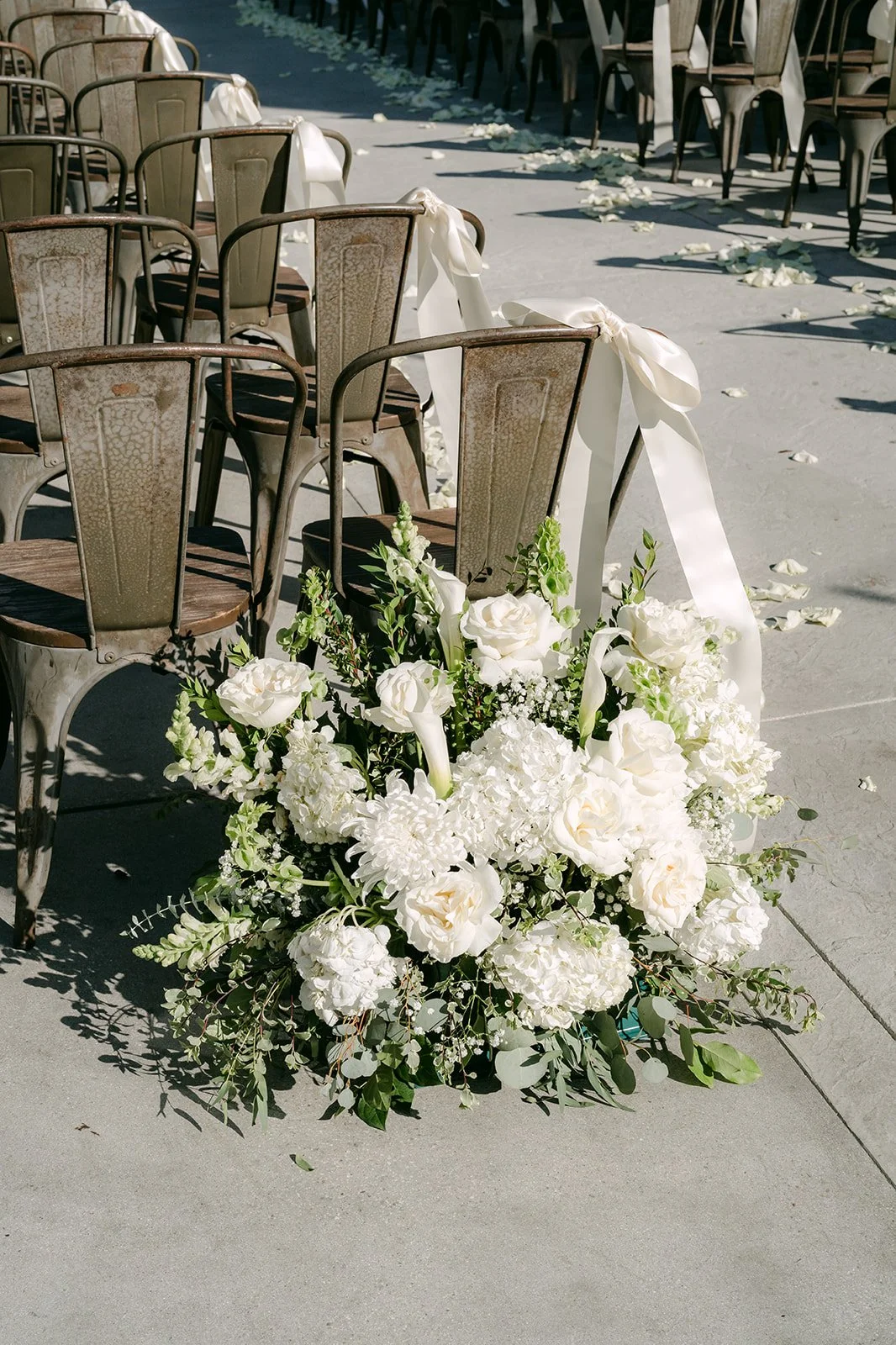 White floral arrangement at the end of the aisle