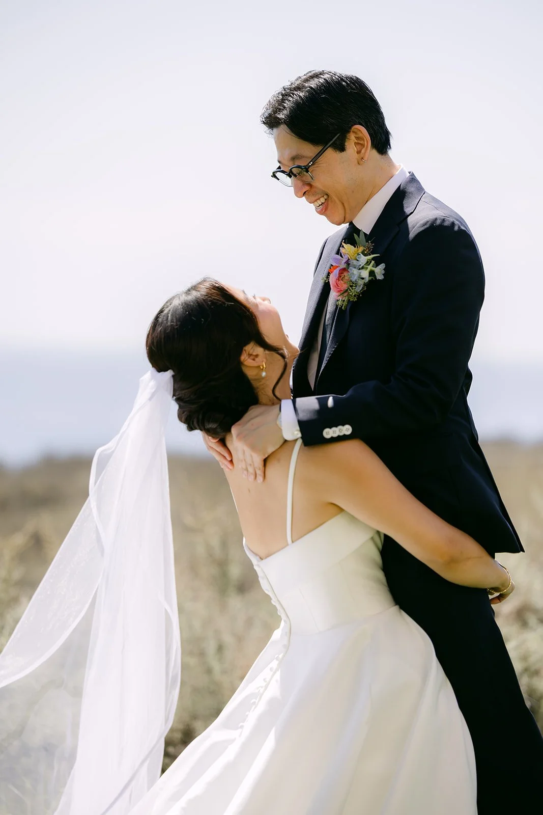 Leroy embracing Saya as her veil catches the breeze