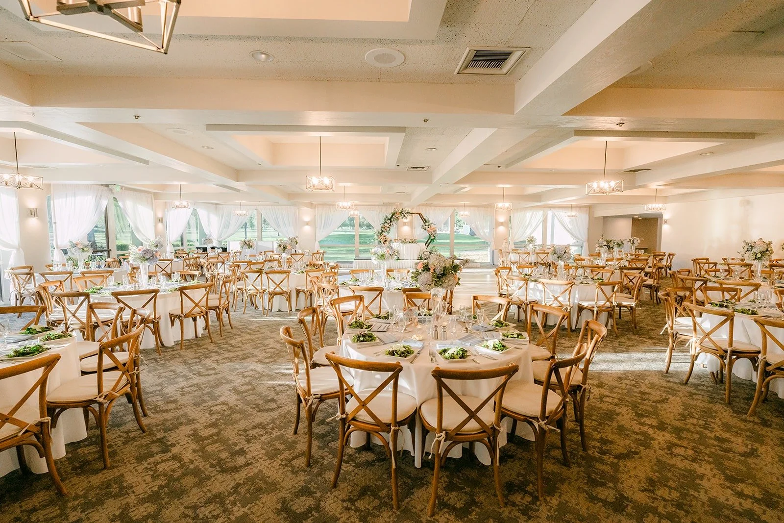 A wide view of the Mediterranean Ballroom set for dinner