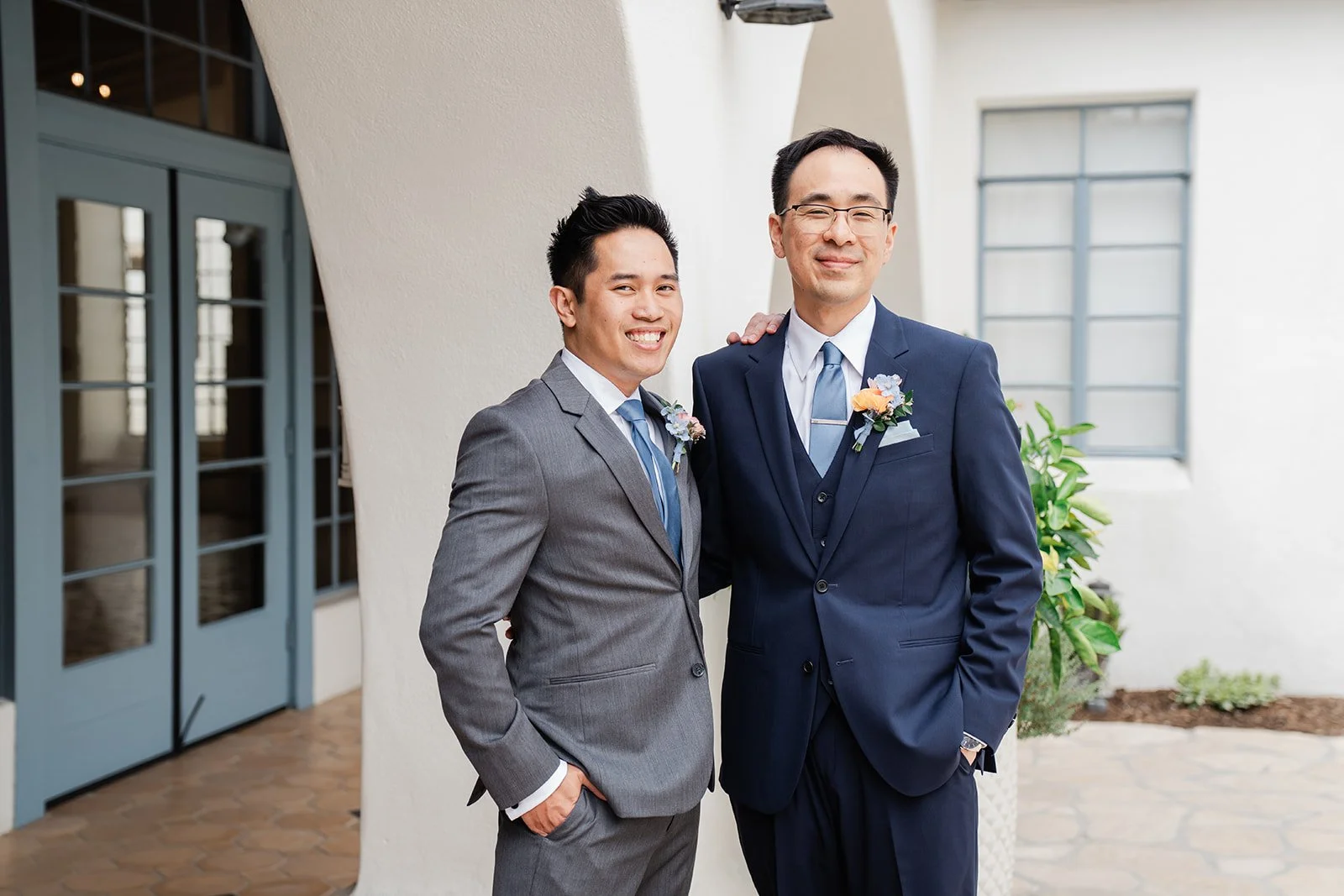 Lawrence with a groomsman by the courtyard doors