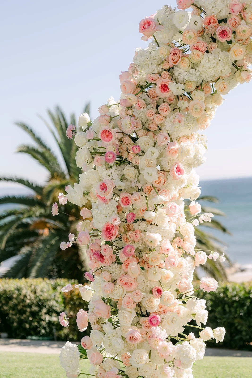 Detail of pink and white roses on the ceremony arch