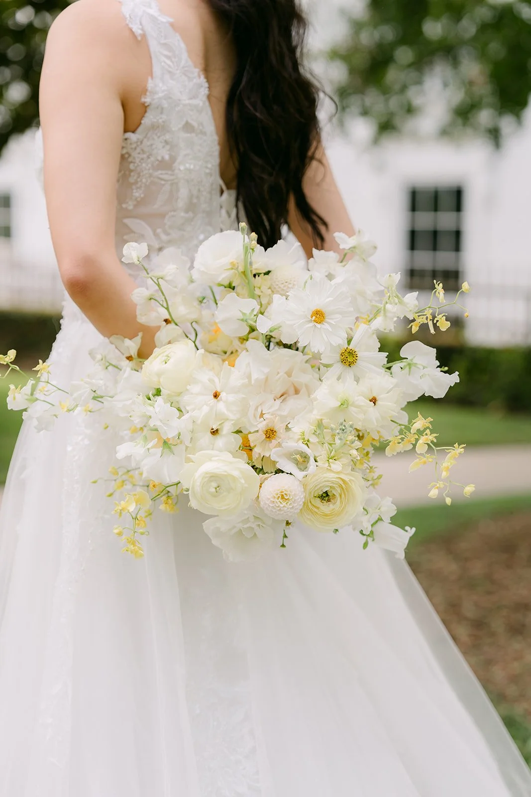 Close-up of Jenny's bouquet of white and butter yellow flowers.