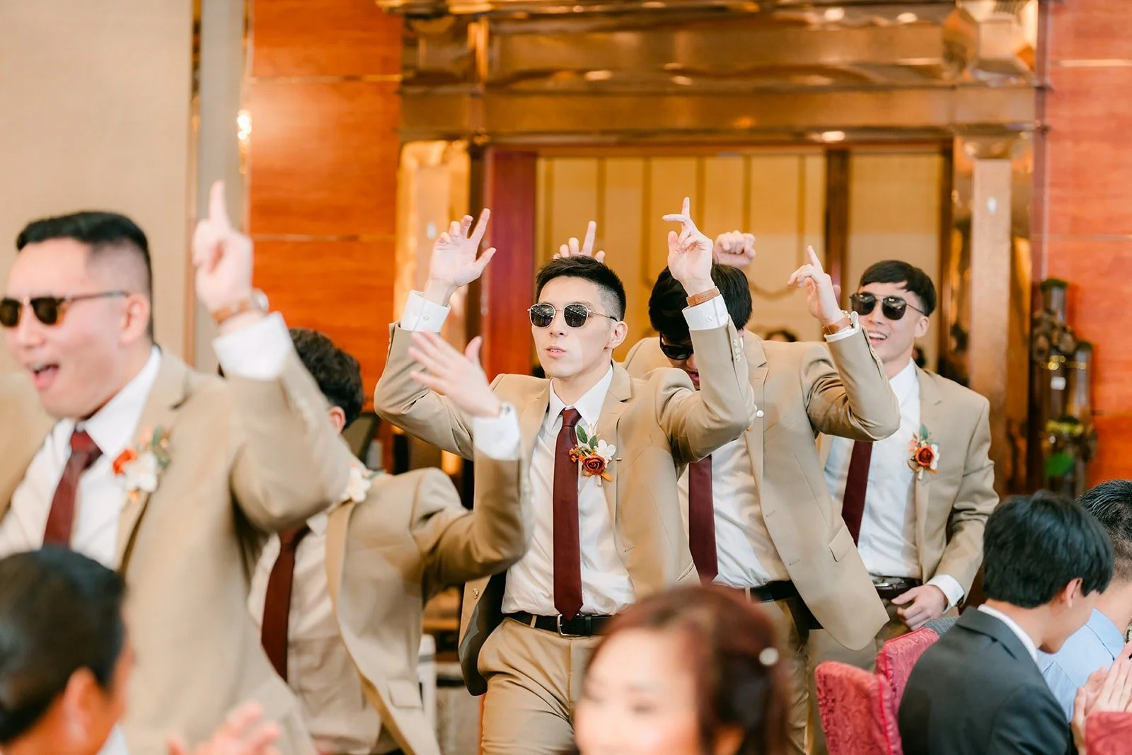 Groomsmen in sunglasses dance into the reception