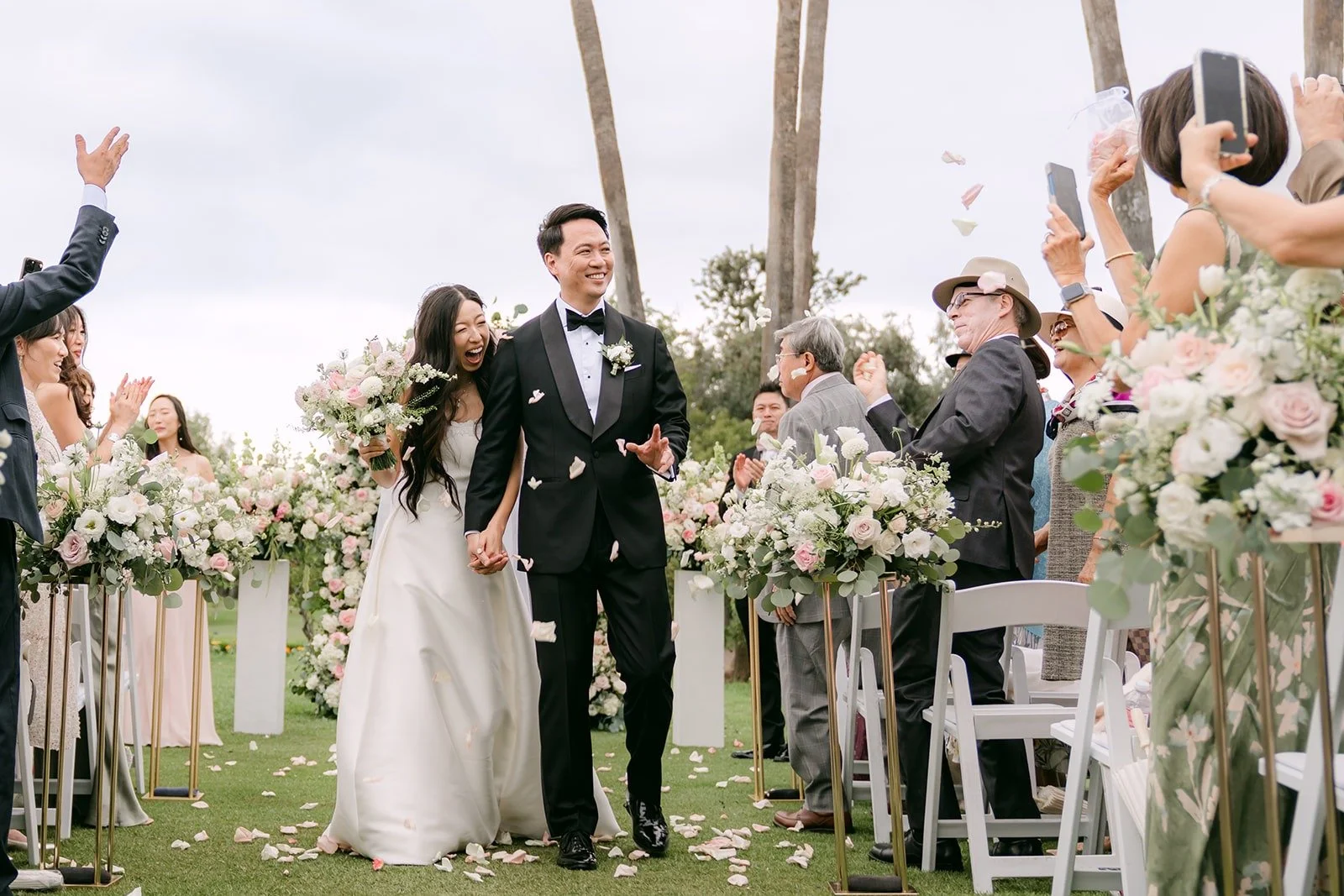 Kristine and William raising their arms as guests cheer