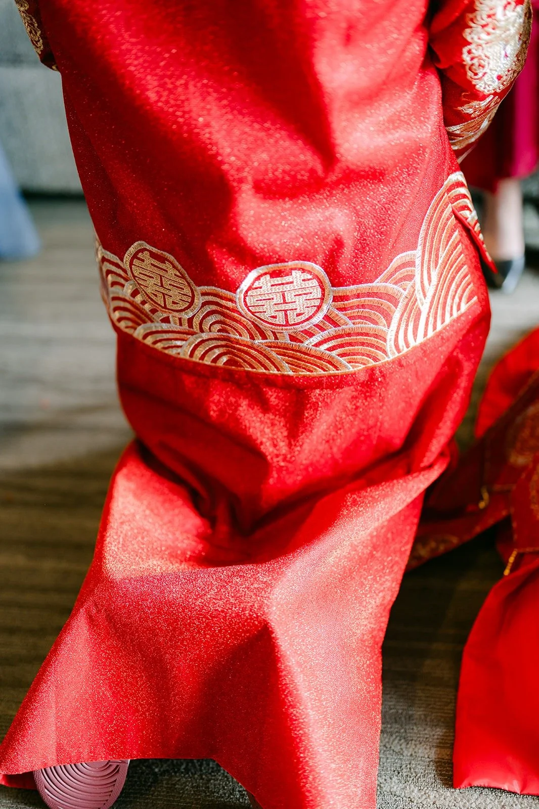 Close up of the gold embroidery on Jay's red tea ceremony attire