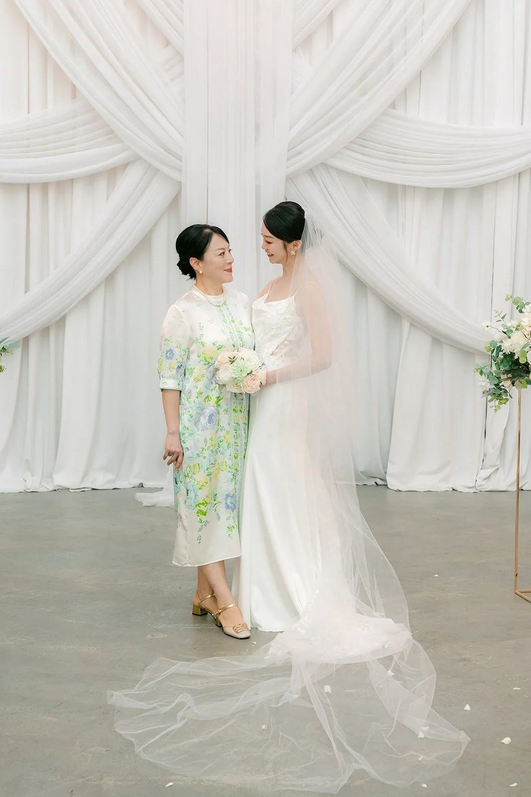 Tin sharing a smile with a family member in the chapel, photographed by One and Only Production