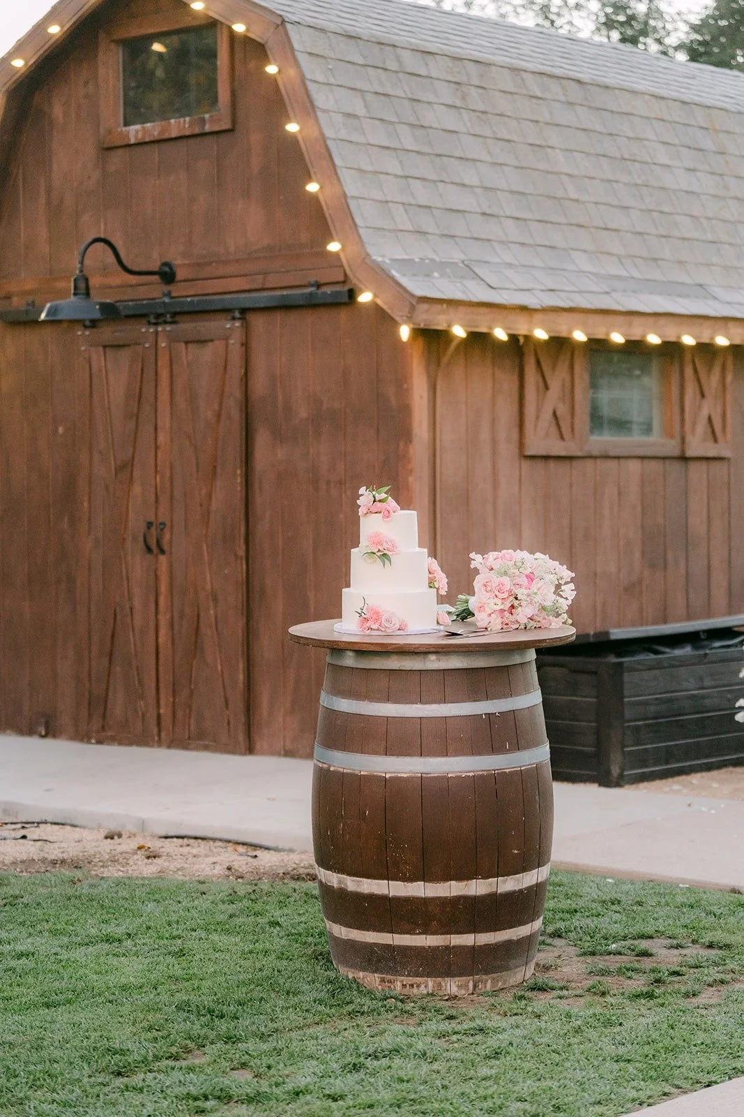 The cake on a wine barrel in front of the Bel Vino barn