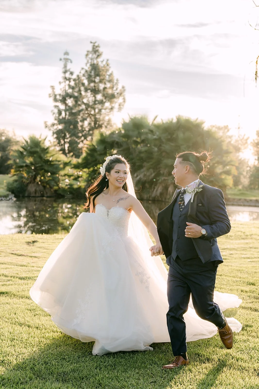Kate and Michael walking hand in hand on the grass.
