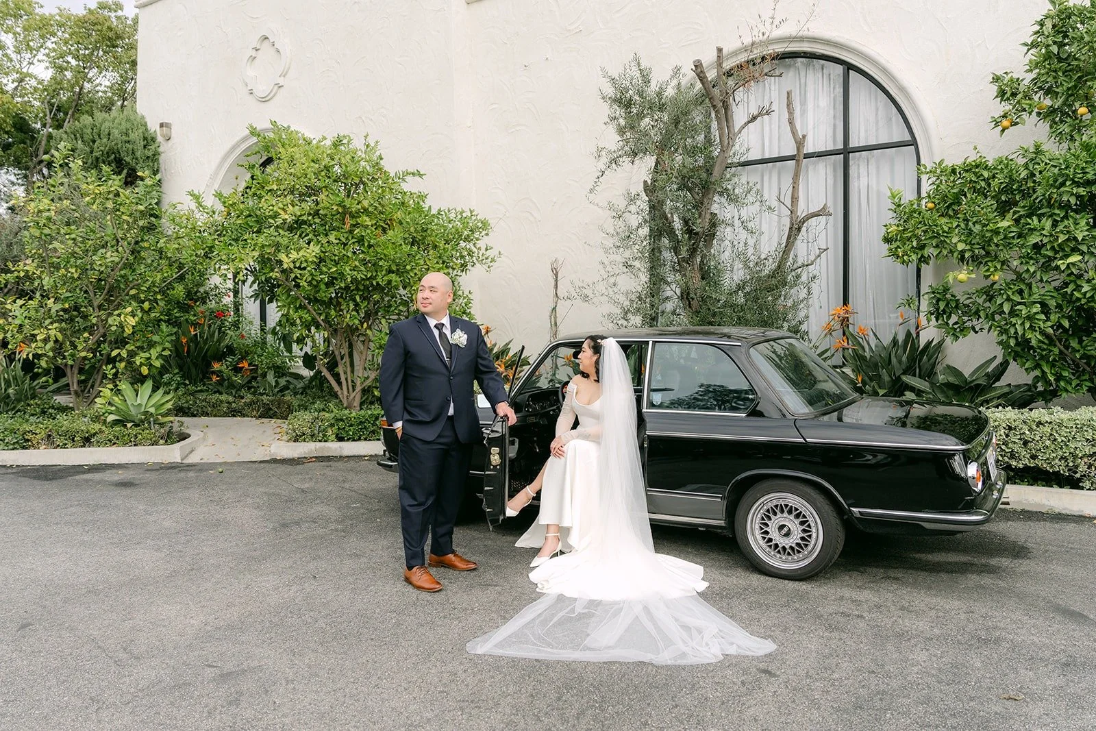 Vivian and Yao beside the vintage car at The Villa