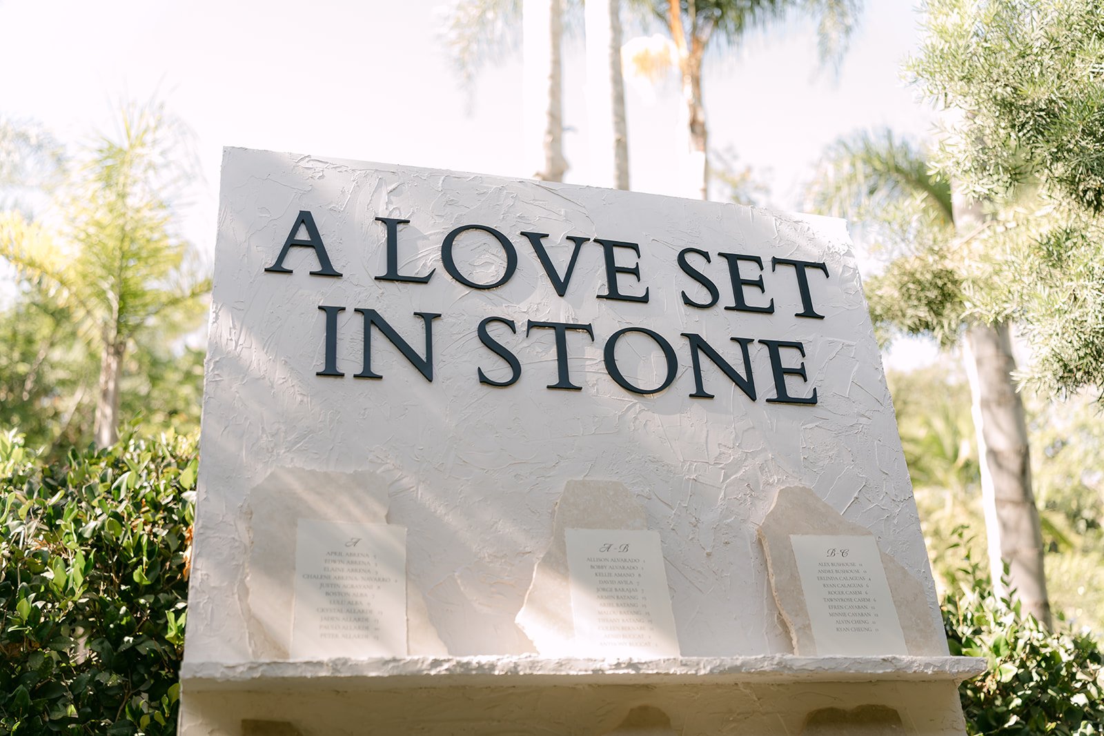 A Love Set in Stone sign at Nicole and Caryl's Eden Gardens reception.