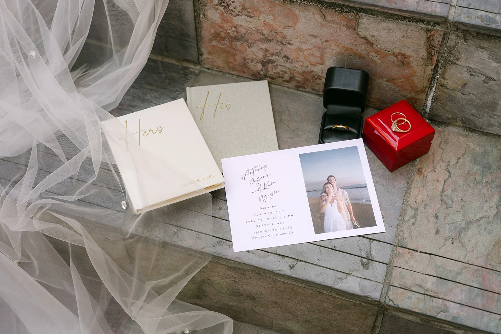 Vow books, invitation and ring box set out for detail photos, photographed by One and Only Production