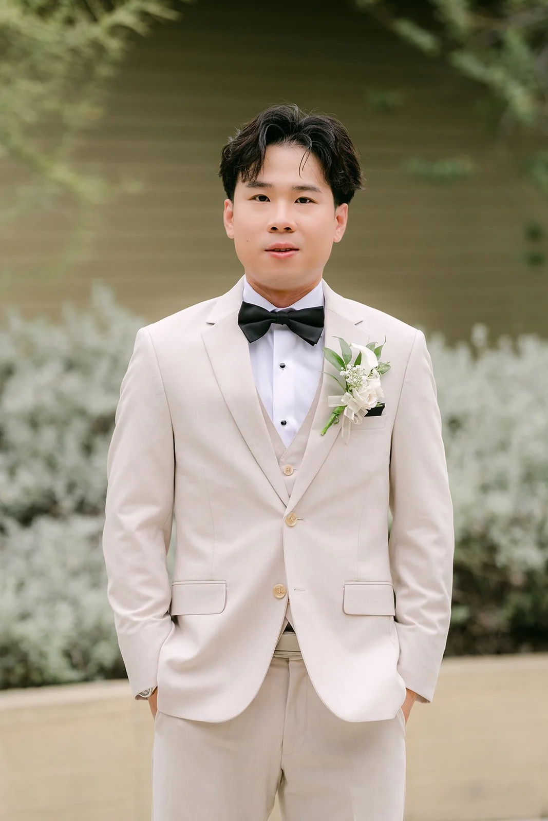 Wen with his hands in his pockets outside.