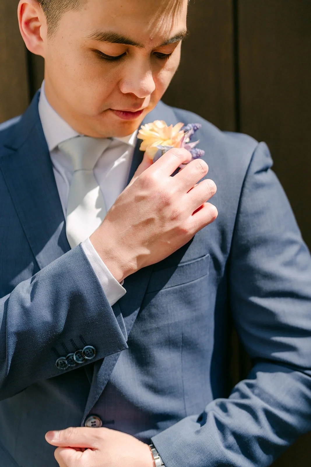 Jerrick adjusting his boutonniere