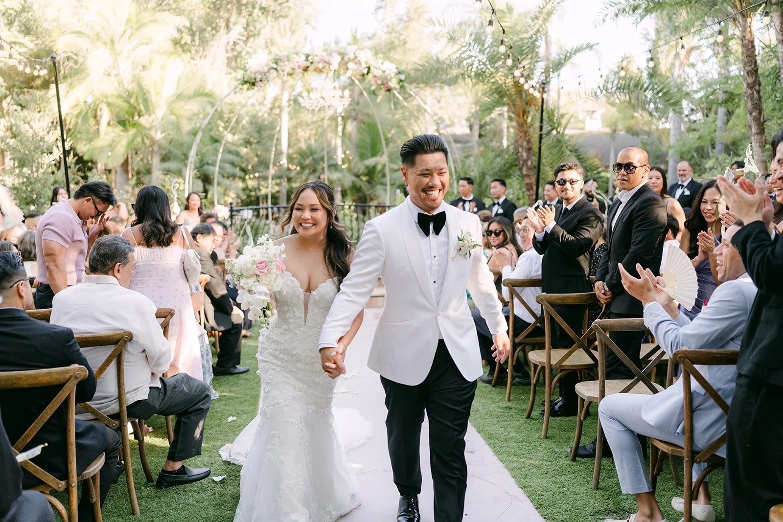 Nicole and Caryl walking back up the aisle as husband and wife.