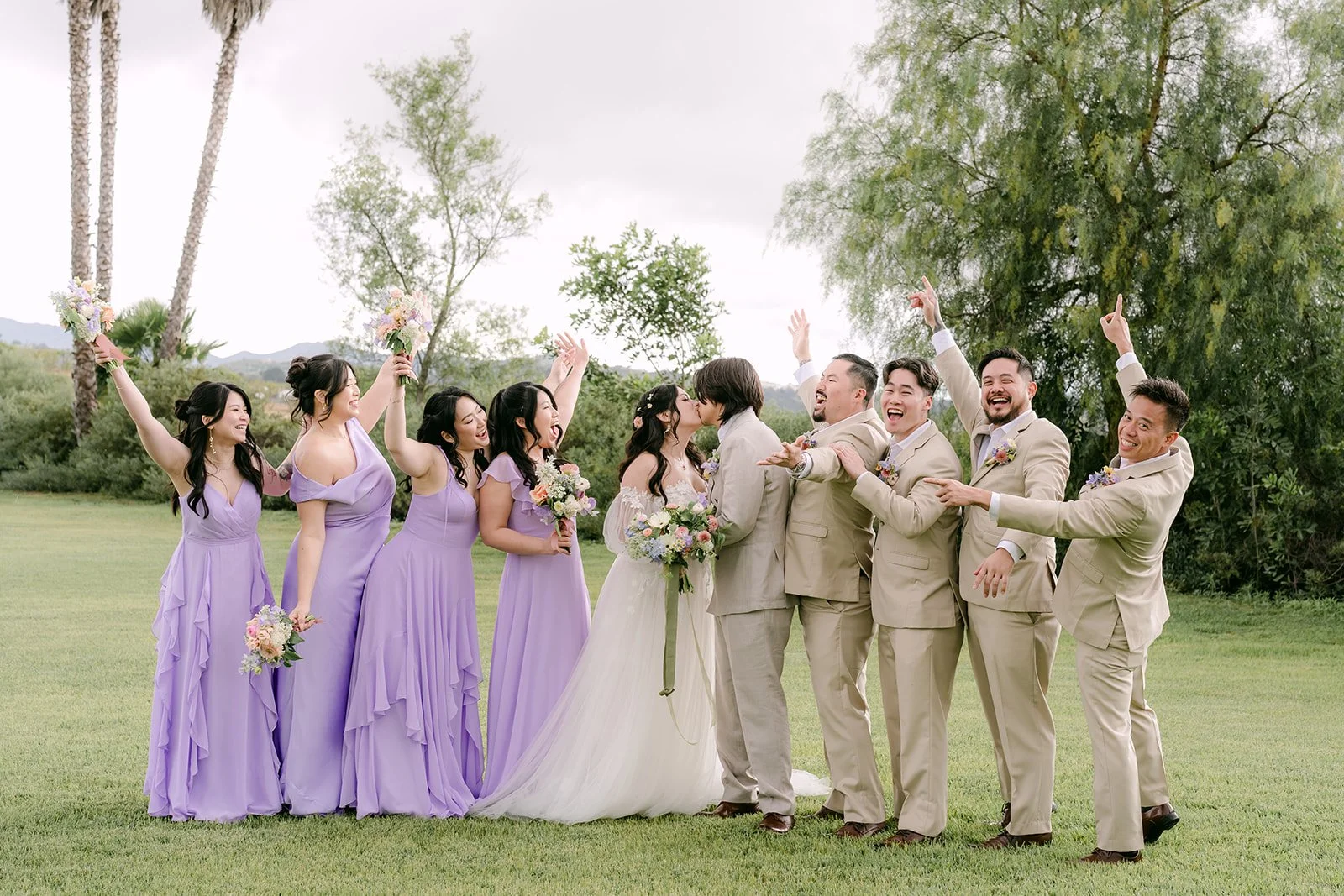 Wedding party cheering on the open lawn