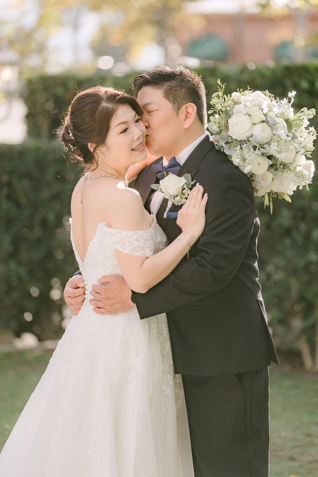Sochi and Jay cheek to cheek with her bouquet