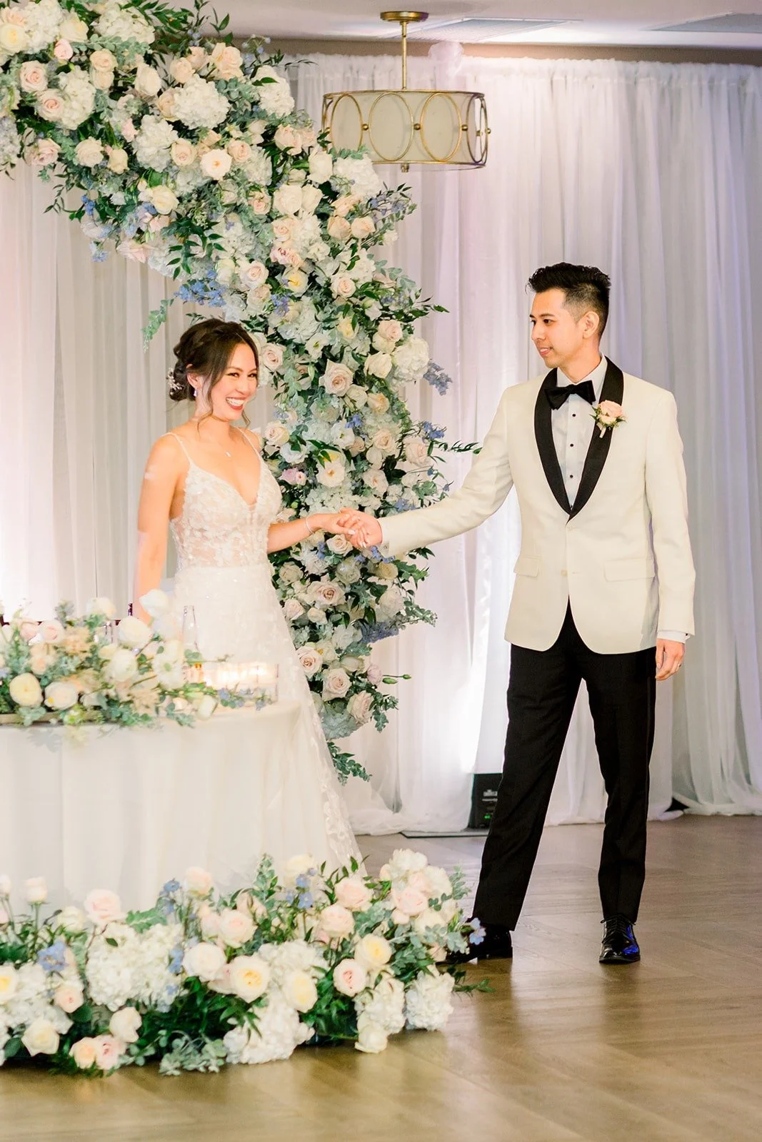 Josephine and David starting their first dance by the floral arch