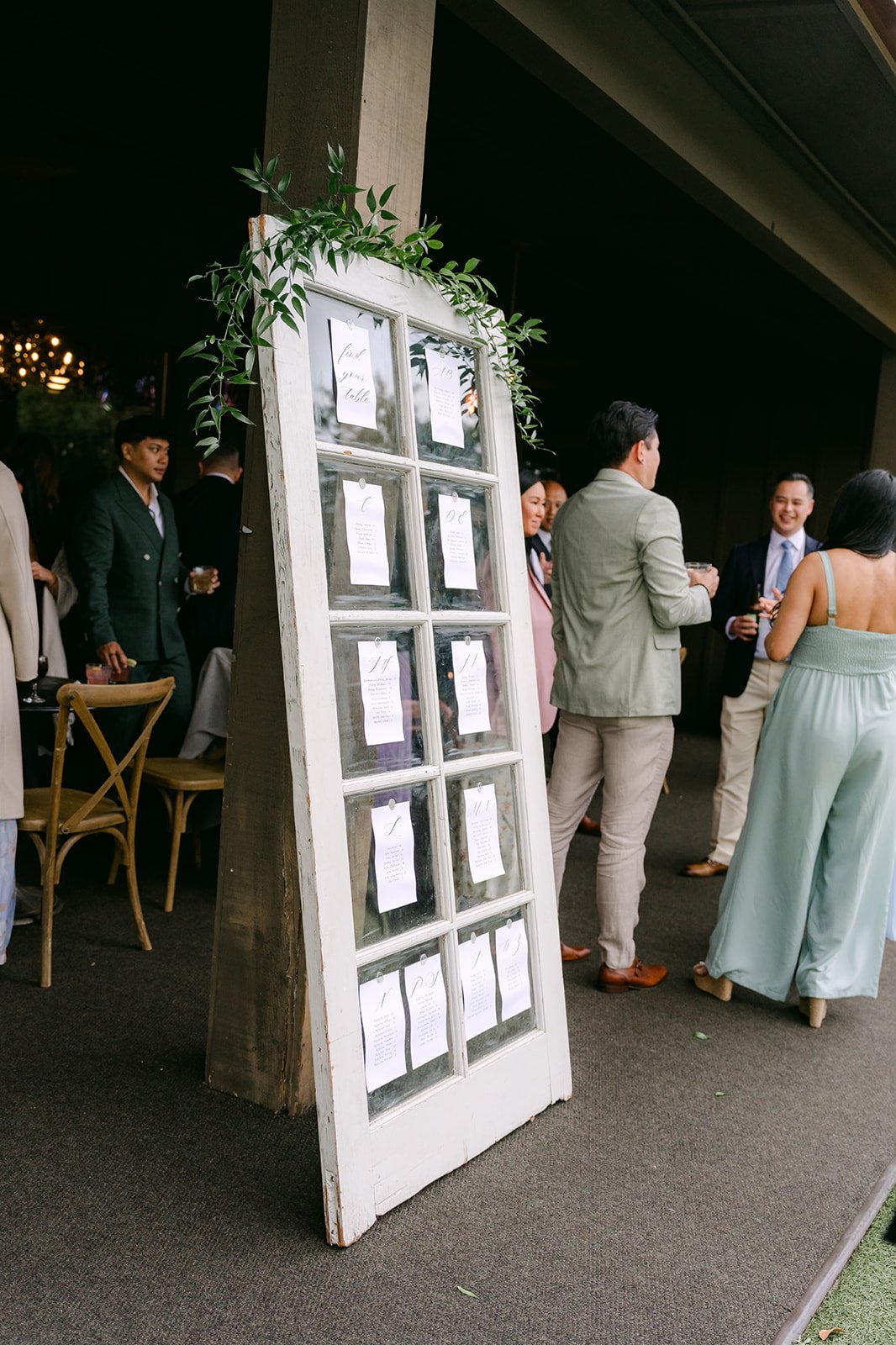 Window pane seating chart framed with greenery