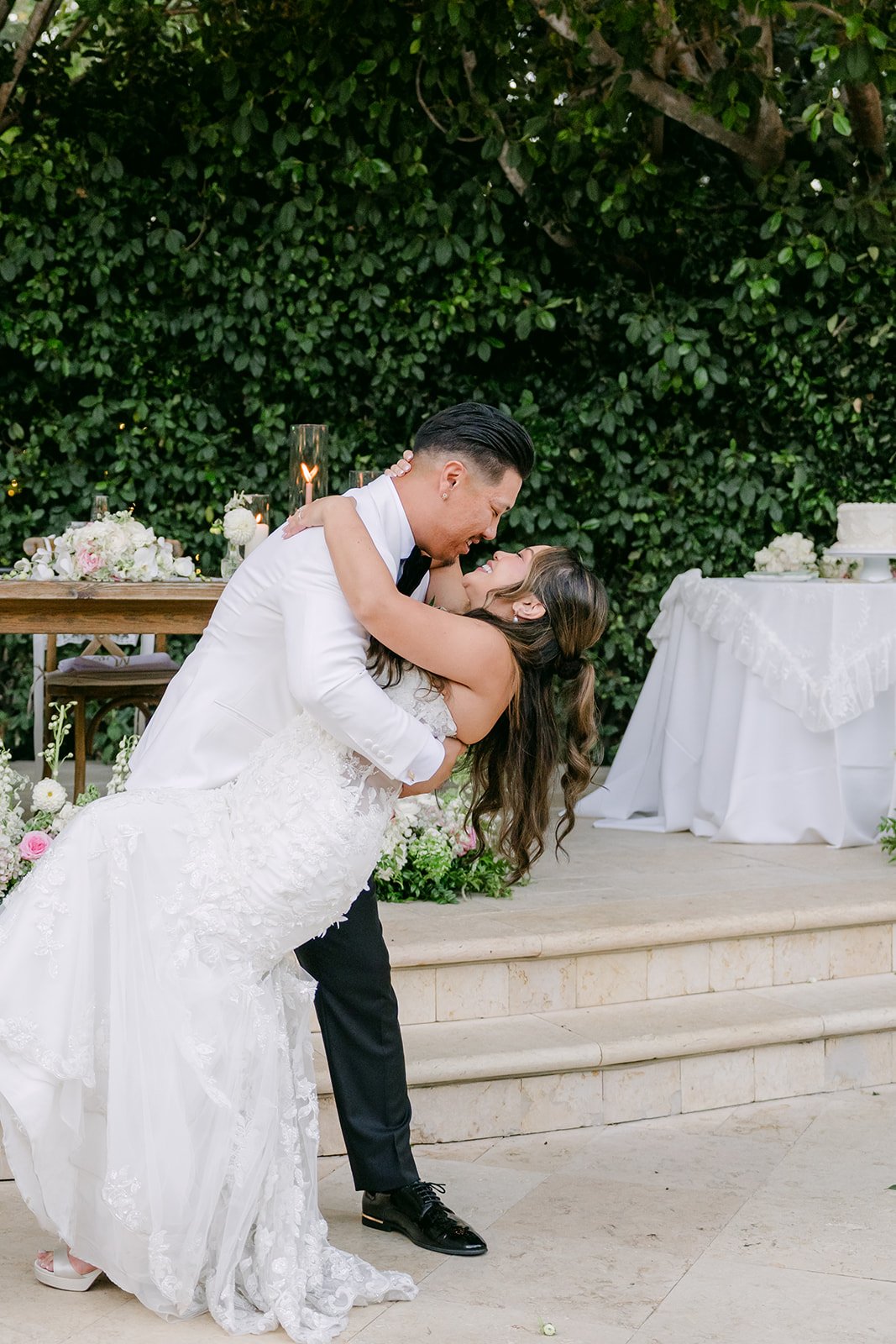 Caryl dipping Nicole for a kiss to end their first dance.