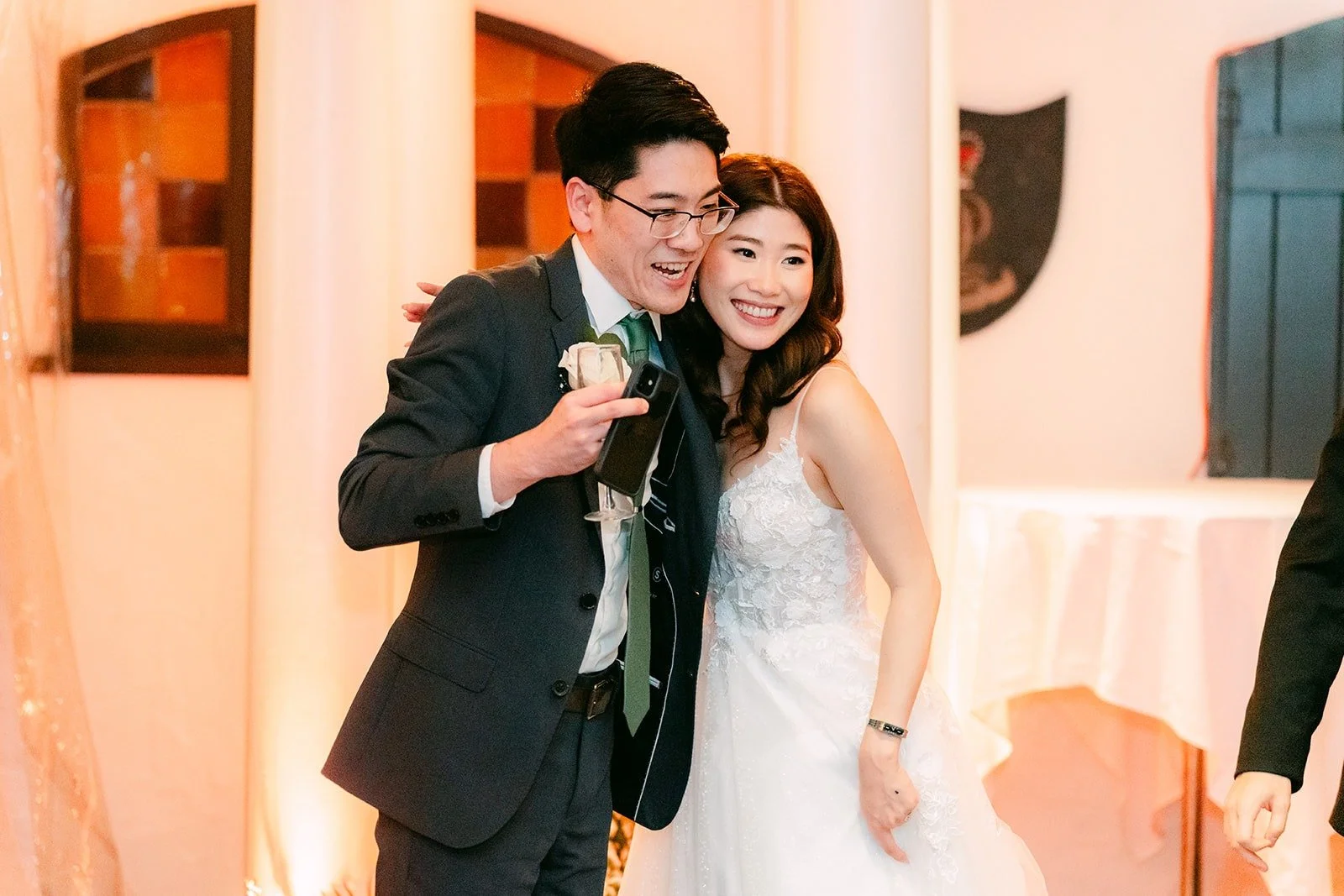 A groomsman speaking with Valerie beside him