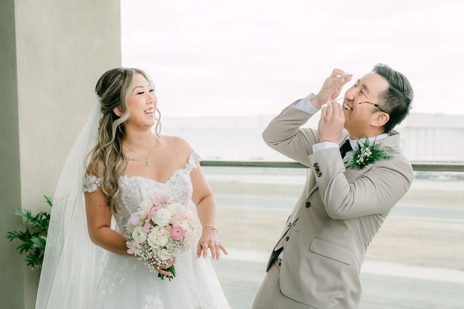 Groom covering his face in happy surprise as he sees his bride