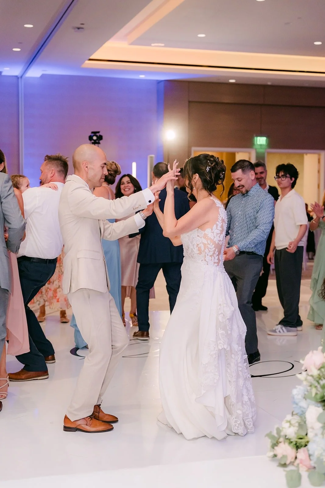 Daniel and Francesca dance under blue ballroom lighting