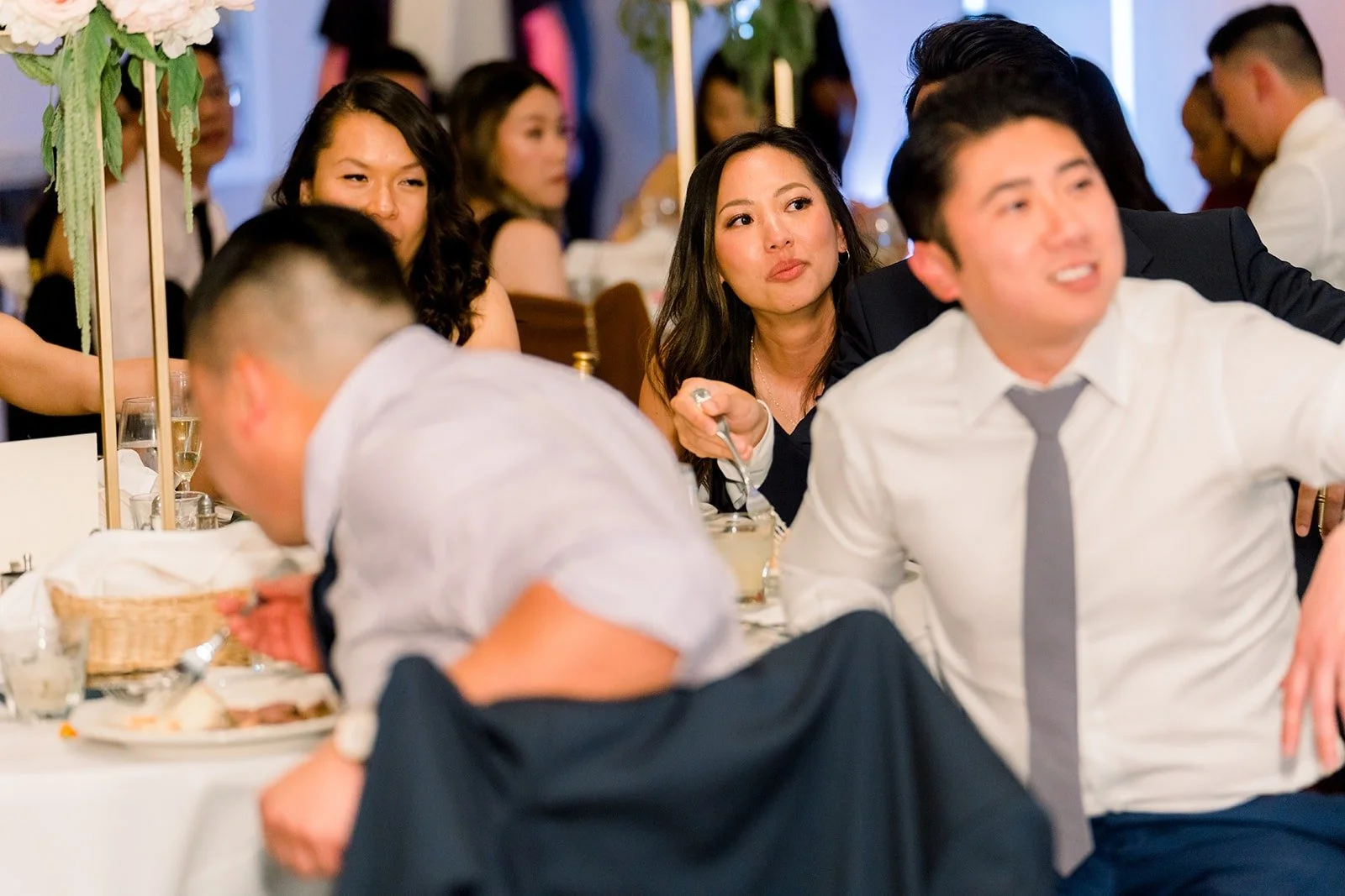 Guests laughing during a toast, photographed by One and Only Production