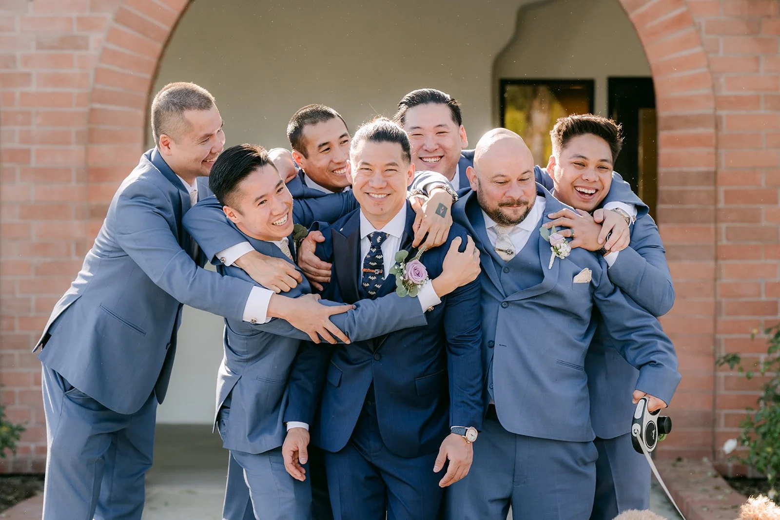 Michael and his groomsmen piling in for a playful hug.
